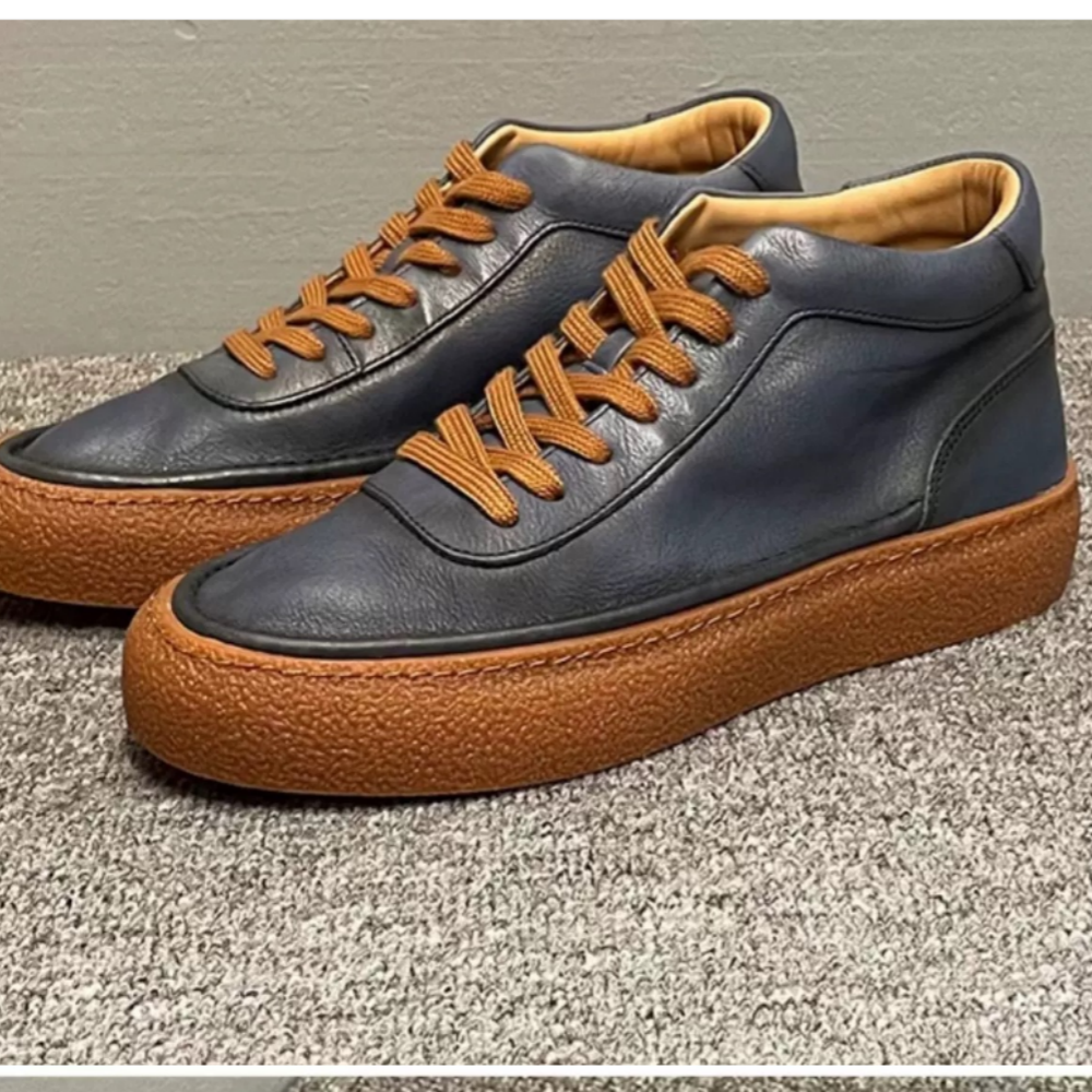 High-top green men's leather boots, designed to be comfortable and soft, are a casual style of boots.