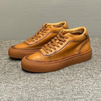 High-top green men's leather boots, designed to be comfortable and soft, are a casual style of boots.