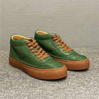 High-top green men's leather boots, designed to be comfortable and soft, are a casual style of boots.