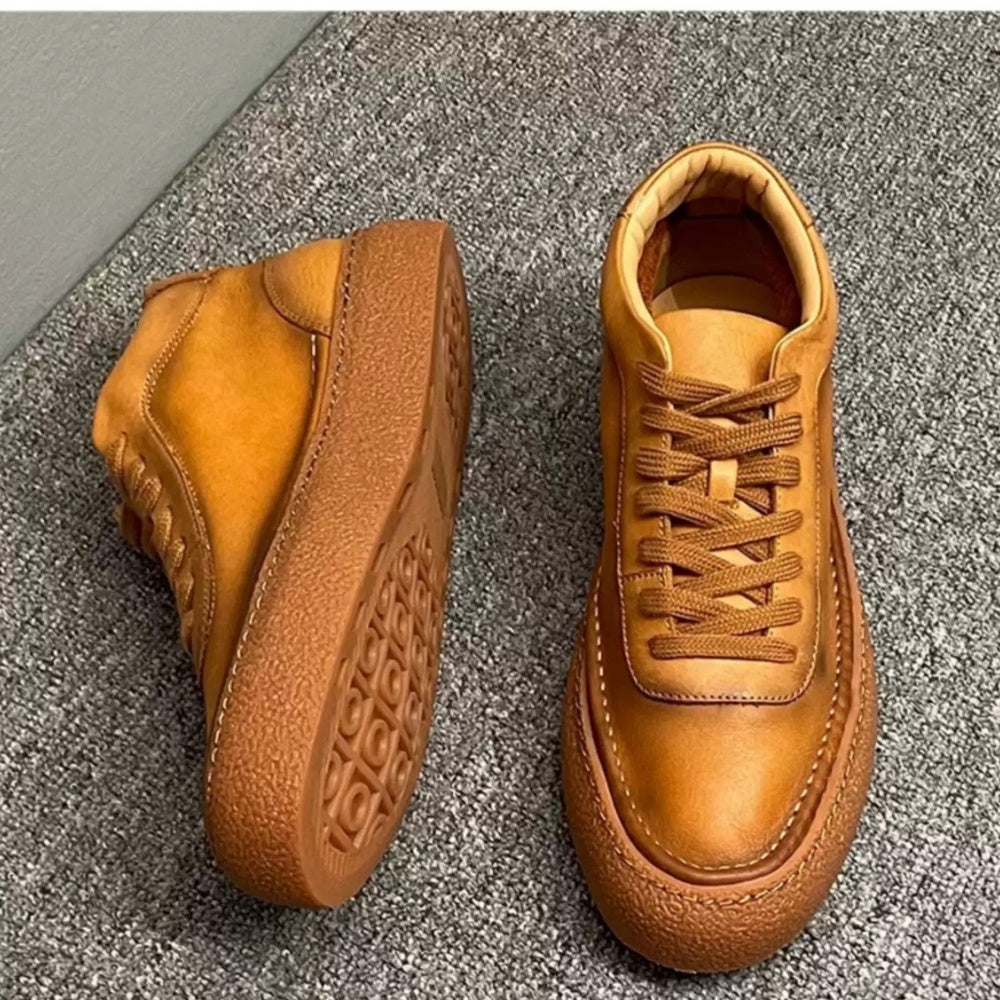 High-top green men's leather boots, designed to be comfortable and soft, are a casual style of boots.