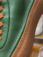 High-top green men's leather boots, designed to be comfortable and soft, are a casual style of boots.
